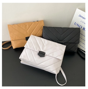 Detailed trio of quilted envelope bags in white, black, and khaki with metal locks