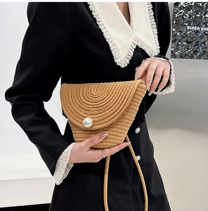 Handmade woven straw mini bucket bag with large pearl buckle for beach vacations
