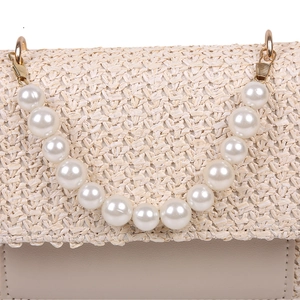 Minimalist beige woven straw crossbody bag with elegant pearl handle and gold buckle