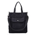 Black corduroy tote bag with front pocket and adjustable strap for casual daily use