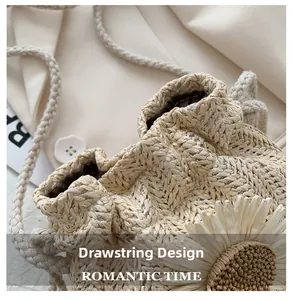 Close-up of woven straw bucket bag showing drawstring design and sunflower ornament