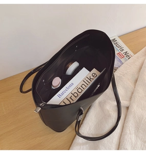 Détails de l'intérieur d'un sac cabas noir en PU montrant sa grande capacité de rangement