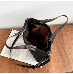 Detailed interior view of a large tote bag with brown suede lining and organizational pockets