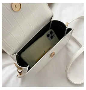 White crocodile texture crossbody bag showing internal capacity for a smartphone