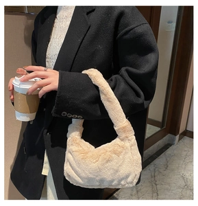 Sac à main en fausse fourrure beige avec un manteau noir pour un look d'hiver chic