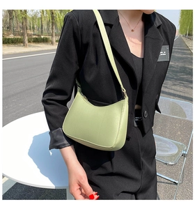 Detail of light green crescent hobo bag made of matte leather with zip closure
