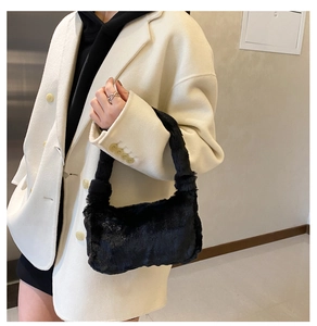 Détail de la texture en fausse fourrure noire douce sur un sac à bandoulière en peluche