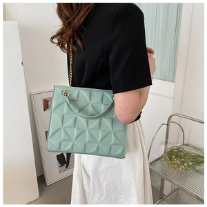 Pale mint green quilted tote bag with geometric pattern and gold chain strap detail