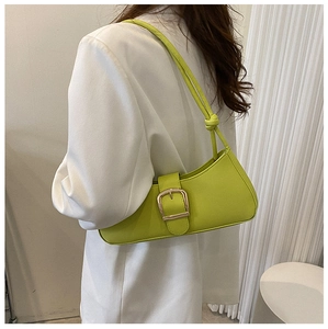 Lime green faux leather shoulder bag with gold buckle detail worn with a white blazer