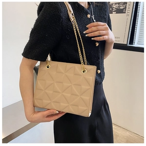 Detail of beige quilted shoulder bag with geometric stitching and golden chain straps