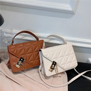 Quilted leather crossbody handbag in brown and white with metallic chain strap