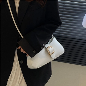 Minimalist white leather shoulder bag with gold horseshoe buckle for elegant women