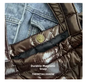 Detail of the secure gold magnetic snap closure on a brown quilted tote bag