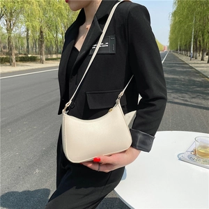 Chic off-white faux leather hobo shoulder bag with sleek minimalist half-moon design