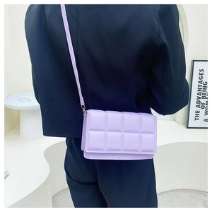 Detail view of the quilted texture and macaron purple finish on a small crossbody bag