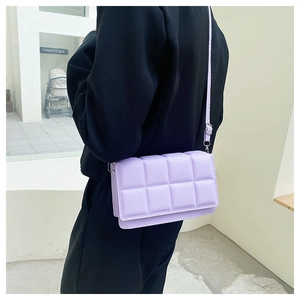 Detail view of lavender quilted crossbody bag with stylish embroidery and metal hooks