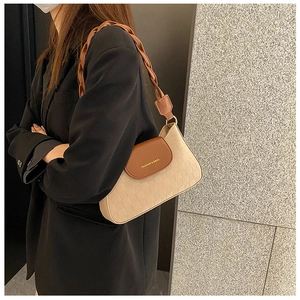 Detail of checkered embossed beige and caramel bag with woven shoulder strap