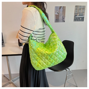 Close-up of fluorescent green hobo bag featuring metallic gloss and quilted rhombus pattern