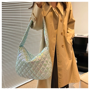 Macro detail of holographic quilted silver tote bag showing glossy diamond patterns