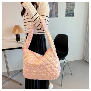 Detail of laser pink tote bag with diamond quilted pattern and metallic finish texture