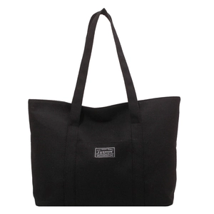 Minimalist black canvas tote bag with large capacity and vintage fashion patch logo