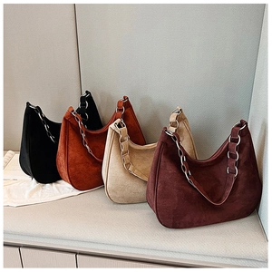Close-up of hobo shoulder bags in matte suede with metallic ring chain straps in four colors