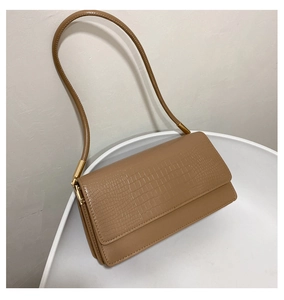 Detailed close-up of crocodile-embossed PU leather with elegant golden metal accents