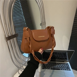 Caramel checkerboard crossbody bag with woven strap and embossed front flap detail