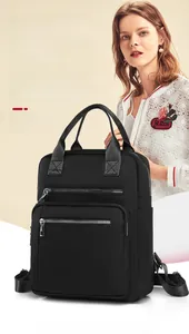Close-up of black quilted nylon backpack featuring durable metal zippers and side pockets