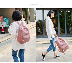 Pink corduroy backpack for women featuring soft texture and front zipper pocket