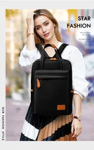 Detail of waterproof black oxford backpack with brown leather trim and side pockets