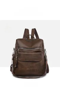 Front view of a brown vintage PU leather backpack with tassel detail and multiple zippers