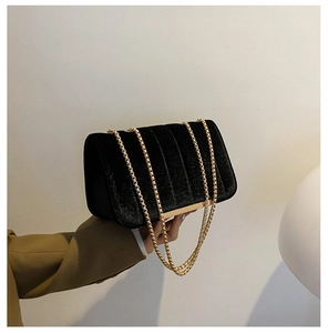 Retro black velvet chain shoulder bag with vertical quilted texture and gold accents