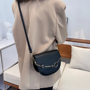 Elegant black leather saddle crossbody bag with gold chain strap and fashion lettering