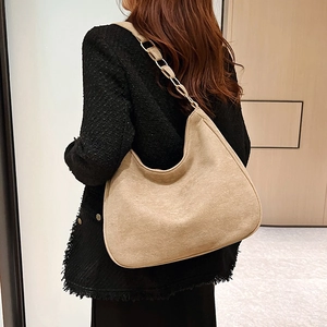 Beige matte faux suede shoulder bag with crescent shape and metal chain strap for women