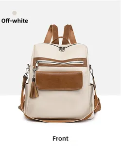 Front view of beige PU leather backpack with contrast stitching and tassel detail