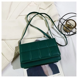 Detailed view of the dark green quilted texture and elegant flap of the square shoulder bag