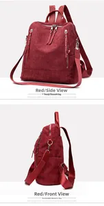 Detailed side view of red corduroy backpack with silver zippers and rivet accents