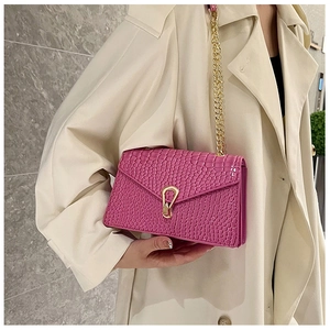 Pink crocodile pattern shoulder bag with gold hollow lock and metal chain on model