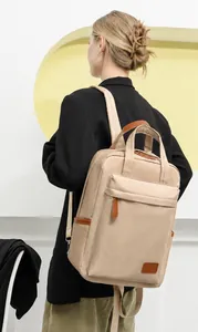 Detailed shot of beige waterproof nylon backpack with brown leather zipper pulls