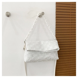 Detailed view of white checkered pattern shoulder bag with plastic chain strap