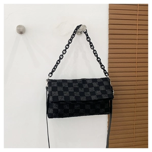 Detailed view of checkered crossbody bag with black chain strap and pleated fabric texture