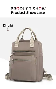 Detail view of khaki waterproof oxford backpack with multi-pocket design and top handle