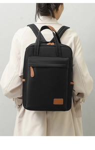 Detailed view of waterproof oxford fabric backpack with stylish brown leather accents