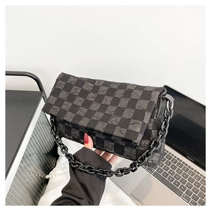 Detail of checkered pattern and pleated texture on crossbody bag with chunky chain strap