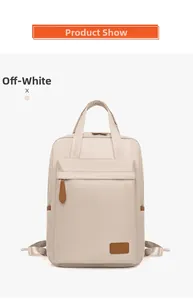 Close-up of beige waterproof Oxford backpack with brown leather zipper pulls and logo detail