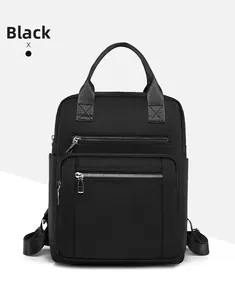 Close-up of black oxford fabric backpack featuring double front zippers and side pocket