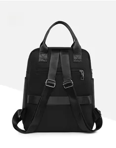 Detail view of the black backpack back with luggage strap and anti-theft zipper pocket