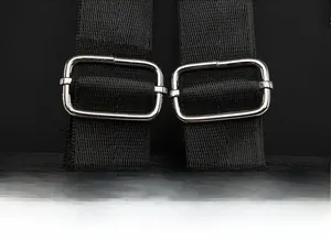 Detail of adjustable black nylon shoulder straps with silver metal buckles on a backpack