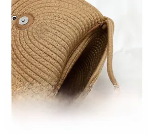 Detail of hand-woven straw bag interior featuring a secure magnetic metal buckle closure